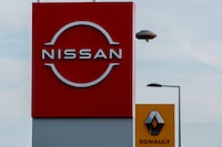 FILE PHOTO: The logos of car manufacturers Renault and Nissan are seen in front of dealerships of the companies in Le Coteau, France, July 13, 2023. REUTERS/Gonzalo Fuentes/File Photo