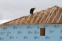 A construction worker works on a house in a new housing development in Oakville, Ont., Friday, April 29. 2011. Calls for co-ordinated action across levels of government to address Canada's housing crisis are growing as affordability deteriorates and the country risks falling even further behind on building more homes. THE CANADIAN PRESS/Richard Buchan