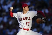 FILE - Los Angeles Angels starting pitcher Shohei Ohtani throws during a baseball game against the Los Angeles Dodgers in Anaheim, Calif., June 21, 2023. Ohtani agreed Saturday, Dec. 9, to a record $700 million, 10-year contract with the Dodgers. (AP Photo/Ashley Landis, File)