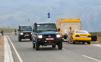 Vehicles of European observers drive past an Armenian checkpoint while leaving Nagorno-Karabakh region near the village of Kornidzor, Armenia, September 23, 2023. REUTERS/Irakli Gedenidze