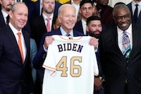 Houston Astros owner Jim Crane and Houston Astros manager Dusty Baker Jr., right, present a jersey to President Joe Biden during an event celebrating the 2022 World Series champion Houston Astros baseball team, in the East Room of the White House, Monday, Aug. 7, 2023, in Washington. (AP Photo/Jacquelyn Martin)