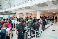 Travels wait in the lineup for WestJet at Toronto Pearson International Airport in Toronto, Ont., on Saturday, July 2, 2022.  Tijana Martin/ The Globe and Mail