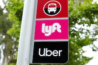 FILE PHOTO: A sign marks a rendezvous location for Lyft and Uber users at San Diego State University in San Diego, California, U.S., May 13, 2020.      REUTERS/Mike Blake/File Photo