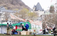 Pro-Palestinian activists are seen in their encampment set up on McGill University's campus in Montreal, Monday, April 29, 2024. The university says it will make efforts to de-escalate before asking for police help with a camp that's been set up on campus by pro-Palestinian activists. THE CANADIAN PRESS/Christinne Muschi