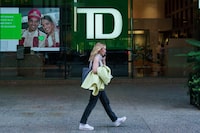 A person walks past a TD Bank sign in the financial district in Toronto on Tuesday, Sept. 20, 2022. THE CANADIAN PRESS/Alex Lupul