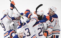 Edmonton Oilers players celebrate a goal by teammate Evan Bouchard against the Montreal Canadiens during overtime period NHL hockey action in Montreal, Saturday, Jan. 13, 2024. THE CANADIAN PRESS/Graham Hughes
