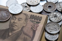 This photo illustration taken on April 10, 2024 shows Japanese yen coins and 10,000 yen notes (65 USD) on display in Tokyo.