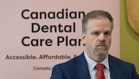 Minister of Health Mark Holland listens to a question following an announcement on dental care, Monday, December 11, 2023 in Ottawa. The federal government has announced enrolment details for a new federal dental plan that resembles typical insurance coverage, down to the benefits card patients show at the dentists' office. THE CANADIAN PRESS/Adrian Wyld