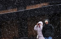People make their way through a heavy snowfall in Ottawa on Thursday, April 4, 2024. A spring storm sweeping through Quebec and Ontario has left tens of thousands in the dark as the significant system rolled through on Thursday. THE CANADIAN PRESS/Sean Kilpatrick
