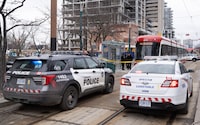 Police cars surround a TTC streetcar on Spadina Ave., in Toronto on Tuesday, January 24, 2023.  Police say a person was stabbed multiple times on a Toronto streetcar. They say the victim was sent to hospital and a suspect was arrested at the scene. THE CANADIAN PRESS/Arlyn McAdorey