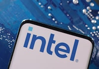 A smartphone with a displayed Intel logo is placed on a computer motherboard in this illustration taken March 6, 2023. REUTERS/Dado Ruvic/Illustration