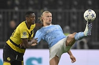 YB's Mohamed Ali Camara, left, vies for the ball with Manchester City's Erling Haaland, during the Champions League group G soccer match between BSC Young Boys and Manchester City, at the Wankdorf stadium, in Bern, Switzerland, Wednesday, Oct. 25, 2023. (Anthony Anex/Keystone via AP)