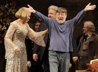 FILE - Conductor Andrew Davis, right, raises his arms as he takes a bow, accompanied by Renee Fleming, and Peter Rose, center, during the final dress rehearsal of Richard Strauss's "Capriccio" in the Metropolitan Opera at New York's Lincoln Center, March 25, 2011. Davis, the acclaimed British conductor who was music director of the Lyric Opera of Chicago and orchestras on three continents, has died, Saturday, April 20, 2024. He was 80. (AP Photo/Richard Drew, file)
