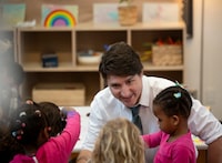 Prime Minster Justin Trudeau chats with children in child care at Don Christian Recreation Centre in Surrey, B.C., Thursday, March 28, 2024.  THE CANADIAN PRESS/Tijana Martin