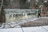 FILE - A woman walks by a Cornell University sign on the Ivy League school's campus, Jan. 14, 2022, in Ithaca, N.Y. Patrick Dai, a Cornell University student accused of posting violently threatening statements against Jewish people on campus shortly after the start of the war in Gaza last fall, pleaded guilty in federal court Wednesday, April 10, 2024. (AP Photo/Ted Shaffrey, File)