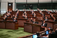 Lawmakers vote for Article 23 in the chamber of the Legislative Council after the conclusion of the readings of the Article 23 National Security Law, in Hong Kong on March 19, 2024. Hong Kong's legislature unanimously passed a new national security law on March 19, introducing penalties such as life imprisonment for crimes related to treason and insurrection, and up to 20 years' jail for the theft of state secrets. (Photo by Peter PARKS / AFP) (Photo by PETER PARKS/AFP via Getty Images)