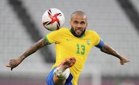 FILE - Brazil's Dani Alves kicks the ball during a men's soccer semifinal match at the 2020 Summer Olympics, Tuesday, Aug. 3, 2021, in Kashima, Japan.  Brazilian soccer player Dani Alves has been arrested after being accused of sexually abusing a woman in Barcelona it was reported on Friday, Jan. 20, 2023. Police say the alleged act took place on Dec. 31 at a night club in Barcelona. (AP Photo/Andre Penner, File)