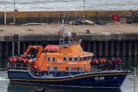 DOVER, ENGLAND - APRIL 23: Migrants are brought into Dover Port by a RNLI lifeboat after being picked up in the English Channel while trying to make the journey from France in inflatable dinghies on April 23, 2024 in Dover, England. At least five migrants are reported to have died whilst crossing the Channel in small boats from France this morning. Last night the UK government's Safety Of Rwanda Bill finally completed its passage through parliament. (Photo by Chris J Ratcliffe/Getty Images)