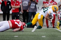 Edmonton Elks wide receiver Trevor Begue (81) is tripped up by Calgary Stampeders linebacker Josiah Schakel (27) during first half CFL exhibition football action in Calgary on Monday May 22, 2023. The CFL's annual Battle of Alberta on Labour Day in Calgary features a pair of West Division clubs with gaps between themselves and a playoff spot.THE CANADIAN PRESS/Larry MacDougal
