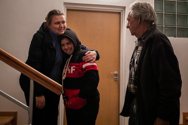 Mr. Krolicki, Ukrainian refugee Olha Voronetska and her 13-year old daughter Anastasia stand in the corridor of Mr. Krolicki's home in Poland.