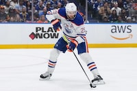 Edmonton Oilers' Leon Draisaitl passes the puck during the first period in Game 1 of an NHL hockey Stanley Cup second-round playoff series against the Vancouver Canucks, in Vancouver, on Wednesday, May 8, 2024. THE CANADIAN PRESS/Darryl Dyck