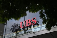 (FILES) This photograph taken on August 31, 2023, shows a sign of Swiss banking giant UBS displayed in a building after the announcement by UBS of the first results since Credit Suisse merger. In a press release on November 7, 2023, Swiss bank UBS announced a heavier-than-expected net loss of 785 million dollars (732 million euros) for the third quarter, with the integration of Credit Suisse. (Photo by Fabrice COFFRINI / AFP) (Photo by FABRICE COFFRINI/AFP via Getty Images)