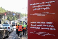 (FILES) People with bicycles stand at the border crossing point Sumskas (Sumsko) between Lithuania and Belarus on August 12, 2023 next to a sign reading "Do not risk your safety -- do not travel to Belarus. You may fail to come back". Lithuania on August 18, 2023 closed two of its six border checkpoints with Belarus in a move it announced earlier this month citing the security risk posed by Russia's Wagner mercenary group. "Both Sumsko and Tvereciaus border checkpoints were shut at midnight," the spokeswoman of the border guard service Lina Laurinaityte-Grigiene told AFP.

Officers laid road spikes at the closed checkpoints and will proceed to erect fences with barbed wire in the area on Friday, she added. (Photo by PETRAS MALUKAS / AFP) / TO GO WITH AFP STORY BY Saulius Jakucionis (Photo by PETRAS MALUKAS/AFP via Getty Images)