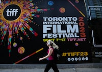 A woman walks along the closed-off streets at the Toronto International Film Festival, in Toronto, Thursday, Sept. 7, 2023. Hollywood A-listers Mark Ruffalo and Rachel McAdams are among 200 plus film industry workers around the world who signed an open letter imploring the Toronto International Film Festival to end ties with sponsor, the Royal Bank of Canada. THE CANADIAN PRESS/Nathan Denette