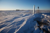 A border marker is shown just outside of Emerson, Man. on Thursday, Jan. 20, 2022. Mounties say autopsies have begun to identify the four people who were found dead in a frigid Manitoba blizzard near the United States border. The bodies, including those of a baby and a teenager, were located on Jan. 19 in the snow near Emerson, Man., just metres from the international border. THE CANADIAN PRESS/John Woods