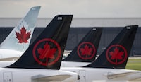 Air Canada logos are seen on the tails of planes at the airport in Montreal, Monday, June 26, 2023.