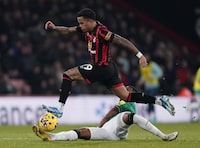 Bournemouth's Justin Kluivert, in air, is challenged by Newcastle United's Jamaal Lascelles, during the English Premier League soccer match between Bournemouth and Newcastle United, at the Vitality Stadium, in Bournemouth, England, Saturday, Nov. 11, 2023. (Andrew Matthews/PA via AP)