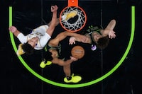New Orleans Pelicans guard Trey Murphy III, center, and guard Dyson Daniels battle under the basket with Los Angeles Lakers center Jaxson Hayes in the second half of an NBA basketball game in New Orleans, Sunday, April 14, 2024. The Lakers won 124-108. (AP Photo/Gerald Herbert)