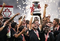 Vancouver Whitecaps' Ryan Raposo hoists the Voyageurs Cup after Vancouver defeated CF Montreal 2-1 in the Canadian Championship soccer final, in Vancouver, on Wednesday, June 7, 2023. The two-legged Telus Canadian Championship quarterfinals kick off Tuesday with the defending champion Whitecaps at Cavalry FC and 2023 runner-up CF Montreal at Forge FC.THE CANADIAN PRESS/Darryl Dyck