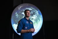 Canadian Space Agency astronaut Jeremy Hansen stands in front of a display as he participates in an interview at the opening of Earth in Focus: Insights from Space, a new exhibition at the Canada Science and Technology Museum in Ottawa, on Friday, Nov. 26, 2021. Hansen has been named the 2023 Calgary Stampede parade marshal. THE CANADIAN PRESS/Justin Tang