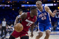 Miami Heat's Jimmy Butler, left, drives to the basket against Philadelphia 76ers' Nicolas Batum during the first half of an NBA basketball play-in tournament game Wednesday, April 17, 2024, in Philadelphia. (AP Photo/Chris Szagola)