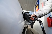 A woman gasses up at a gas station in Mississauga, Ont.,  Tuesday, February 13, 2024. Ontario Premier Doug Ford says his government will introduce legislation that would put any future provincial carbon pricing program to a referendum. THE CANADIAN PRESS/Christopher Katsarov