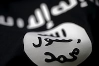 FILE PHOTO: An Islamic State flag is seen in this picture illustration taken February 18, 2016. Picture taken February 18, 2016. REUTERS/Dado Ruvic/Illustration/File Photo