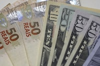 Brazilian Real and U.S. dollar notes are pictured at a currency exchange office in Rio de Janeiro, Brazil, in this September 10, 2015 photo illustration.