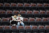 Arizona Coyotes fans sit in their seats long after the team's NHL hockey game against the Edmonton Oilers ended, Wednesday, April 17, 2024, in Tempe, Ariz. The Coyotes won 5-2. Team owner Alex Meruelo agreed to sell franchise's hockey operations to Utah Jazz owner Ryan Smith, who intends to move the team to Salt Lake City. (AP Photo/Ross D. Franklin)