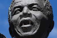 Spider webs can be seen on the face of the Nelson Mandela statue at the entrance of the Groot Drakenstein Correctional Centre where Mandela was imprisoned for the last few years before his release, on the 10th anniversary of his death, outside Cape Town, South Africa, December 5, 2023. REUTERS/Esa Alexander
