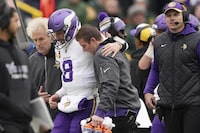 Minnesota Vikings quarterback Kirk Cousins (8) is helped off the field after going down with an injury in the fourth quarter of an NFL game against the Green Bay Packers, Sunday, Oct. 29, 2023, in Green Bay, Wis. (Anthony Souffle/Star Tribune via AP)