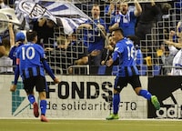 Montreal Impact midfielder Jeisson Vargas (16) reacts with teammate Ignacio Piatti (10) after scoring a goal against Toronto FC during the first half at Olympic Stadium.
