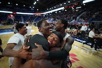 Scarborough Shooting Stars' Kalif Young, second left, Elijah Lufile, third left, and Myck Kabongo, back right, celebrate after Scarborough defeated the Calgary Surge in the CEBL basketball championship final, in Langley, B.C., on Sunday, August 13, 2023. THE CANADIAN PRESS/Darryl Dyck