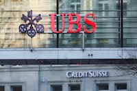 FILE PHOTO: Logos of Swiss banks UBS and Credit Suisse are seen in Zurich, Switzerland March 20, 2023. REUTERS/Denis Balibouse
