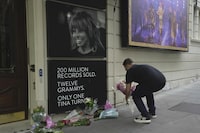 A man places flowers outside the Aldwych Theatre in London, Thursday, May 25, 2023. London's Aldwych Theatre is housing the Tina Turner musical where fans put down tribute to&nbsp;the unstoppable singer and stage performer who died Wednesday, after a long illness at her home in Kuesnacht near Zurich, Switzerland, according to her manager. She was 83.&nbsp; THE CANADIAN PRESS/AP, Kin Cheung