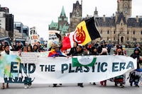 People take part in a 'March to End the Plastic Era' rally on Parliament Hill in Ottawa, on Sunday, April 21, 2024. The fourth session of the Intergovernmental Negotiating Committee (INC) is set to take place in the nation's capital as delegates from 176 countries work to negotiate a treaty to eliminate plastic waste in less than 20 years. THE CANADIAN PRESS/Spencer Colby