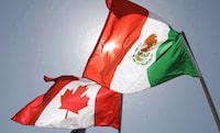 The friend of a London, Ont., woman killed in Mexico during a weekend robbery says she'll remember her friend as someone who loved to travel and had endured a lot of struggles in life. Canadian and Mexican flags fly in New Orleans on April 21, 2008. THE CANADIAN PRESS/AP, Judi Bottoni