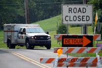 A roadblock is seen as crews search for a a pair of missing children swept away after weekend rains, Monday, July 17, 2023, in Washington Crossing, Pa. (AP Photo/Matt Slocum)