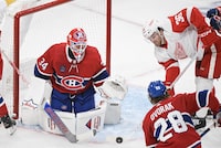 Detroit Red Wings' Christian Fischer (36) moves in on Montreal Canadiens goaltender Jake Allen as Canadiens' Christian Dvorak (28) defends during second period NHL hockey action in Montreal, Saturday, Dec. 2, 2023. THE CANADIAN PRESS/Graham Hughes