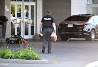 An Ottawa Police officer collects evidence after a Saturday night shooting at the Infinity Convention Centre that left two dead, in Ottawa, on Sunday, Sept. 3, 2023. THE CANADIAN PRESS/Justin Tang